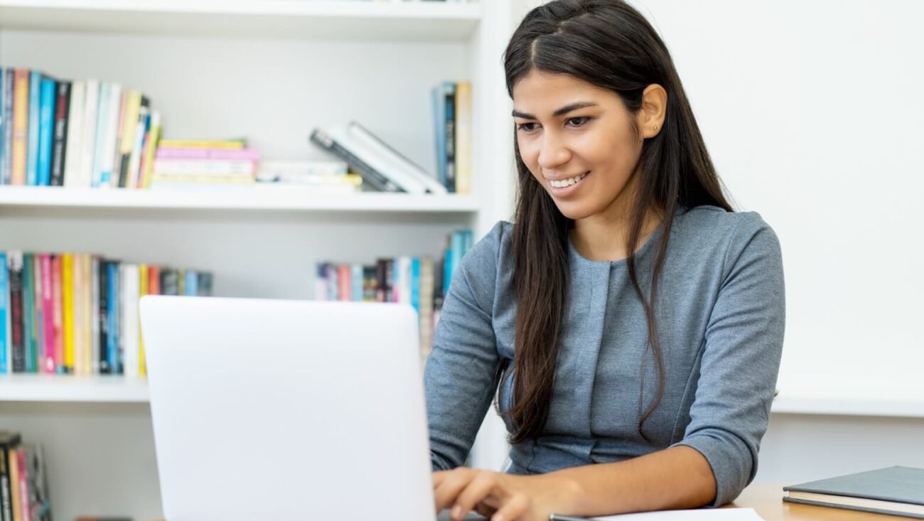 Teacher preparing an online English lesson with a laptop